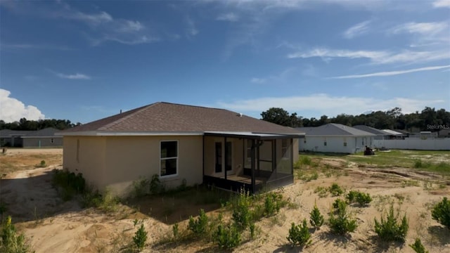 4251 E Walker St, Inverness, FL 34453 - rear view of property featuring a sunroom and stucco siding