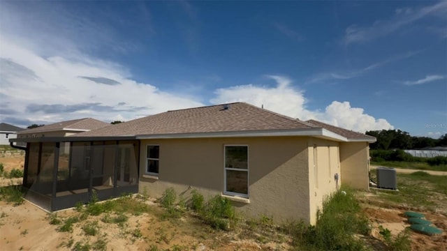 4251 E Walker St, Inverness, FL 34453 - rear view of house with a sunroom and stucco siding