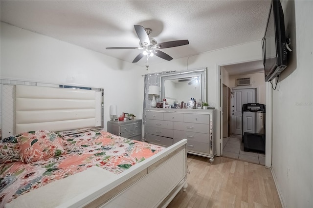 1100 Lowry Ave Unit 7, Lakeland, FL 33801 - bedroom featuring light wood-style flooring, an AC wall unit, a ceiling fan, and connected bathroom