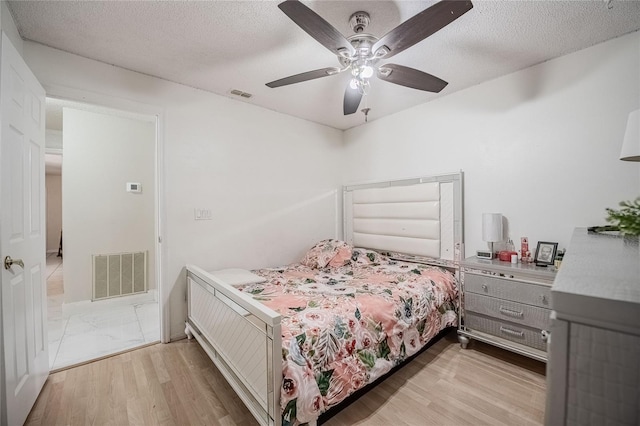 1100 Lowry Ave Unit 7, Lakeland, FL 33801 - bedroom with wood finished floors, a textured ceiling, and a ceiling fan
