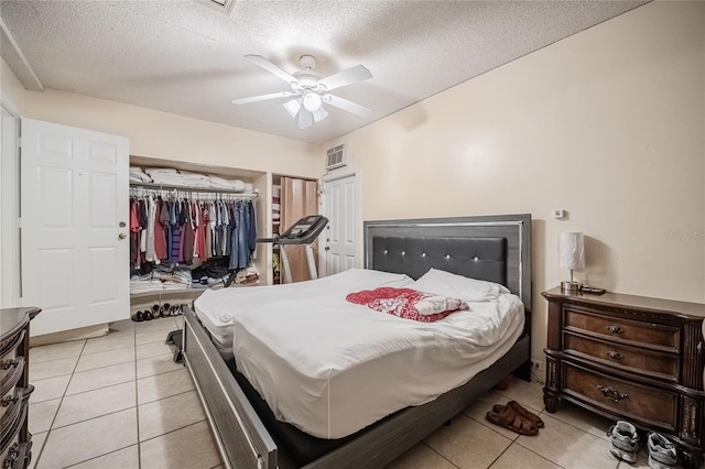 1100 Lowry Ave Unit 7, Lakeland, FL 33801 - bedroom featuring light tile patterned flooring, a textured ceiling, a closet, and a ceiling fan