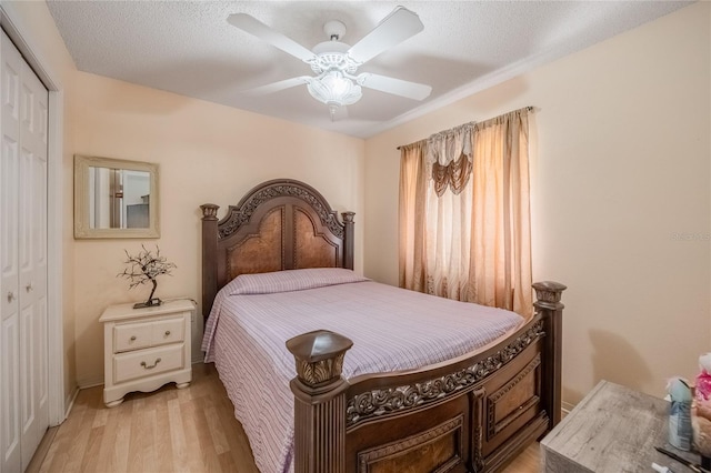 1100 Lowry Ave Unit 7, Lakeland, FL 33801 - bedroom with a closet, light wood-style flooring, ceiling fan, and a textured ceiling
