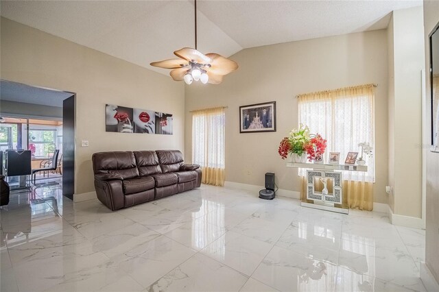 1100 Lowry Ave Unit 7, Lakeland, FL 33801 - living area featuring ceiling fan, marble tiled floors, and vaulted ceiling