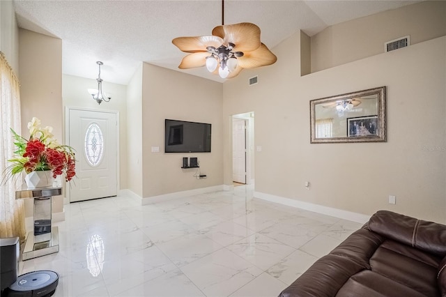 1100 Lowry Ave Unit 7, Lakeland, FL 33801 - living area featuring light marble finish flooring, a ceiling fan, high vaulted ceiling, and a chandelier