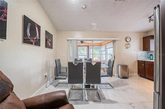 1100 Lowry Ave Unit 7, Lakeland, FL 33801 - dining space featuring light marble finish flooring, a textured ceiling, and ceiling fan