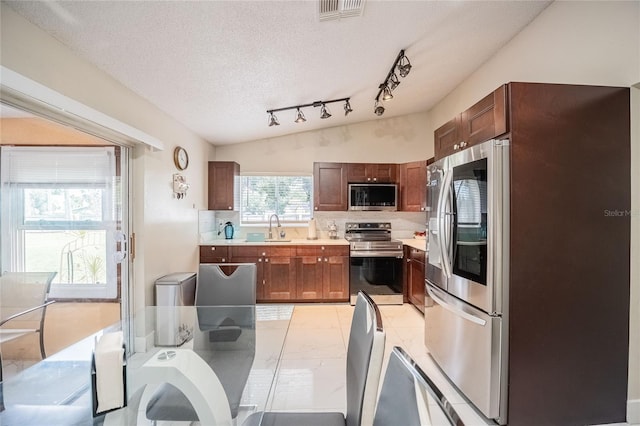 1100 Lowry Ave Unit 7, Lakeland, FL 33801 - kitchen featuring appliances with stainless steel finishes, light countertops, a textured ceiling, and tasteful backsplash
