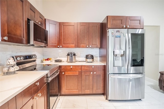 1100 Lowry Ave Unit 7, Lakeland, FL 33801 - kitchen featuring stainless steel appliances, light marble finish flooring, light countertops, and decorative backsplash