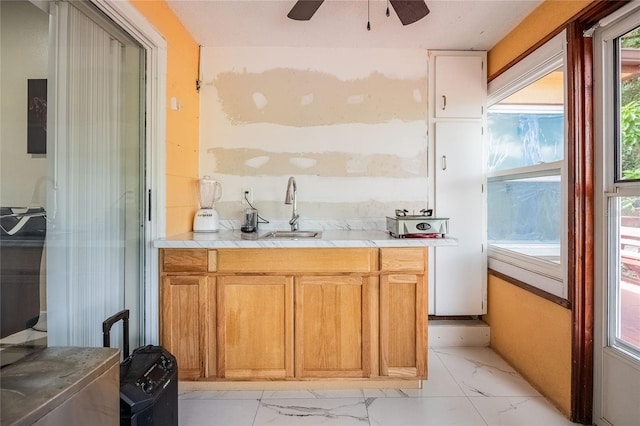 1100 Lowry Ave Unit 7, Lakeland, FL 33801 - kitchen featuring light marble finish flooring, light countertops, and a ceiling fan