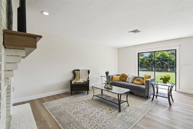 2004 Varner Cir, Winter Haven, FL 33884 - living area featuring a textured ceiling, wood finished floors, and recessed lighting