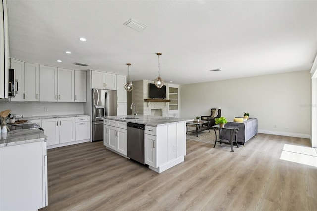 2004 Varner Cir, Winter Haven, FL 33884 - kitchen with backsplash, recessed lighting, light wood-style floors, and appliances with stainless steel finishes
