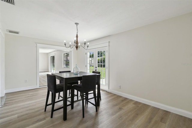 2004 Varner Cir, Winter Haven, FL 33884 - dining space with a chandelier, light wood finished floors, and french doors