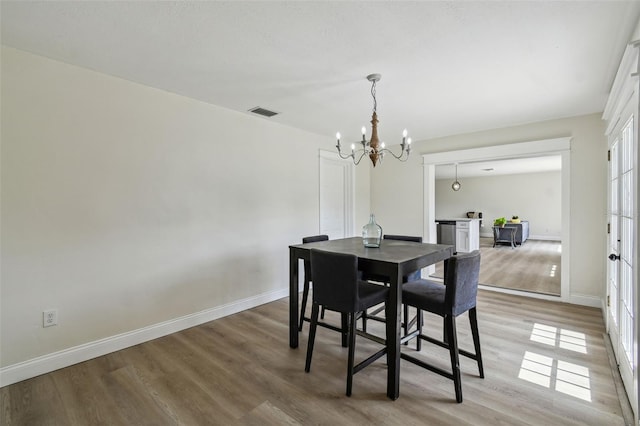 2004 Varner Cir, Winter Haven, FL 33884 - dining room featuring a chandelier and light wood-style floors
