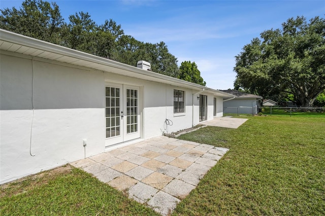 2004 Varner Cir, Winter Haven, FL 33884 - rear view of house with french doors, a patio, stucco siding, and a chimney