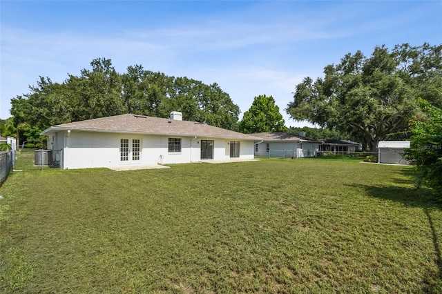 2004 Varner Cir, Winter Haven, FL 33884 - rear view of property featuring french doors, stucco siding, and a fenced backyard