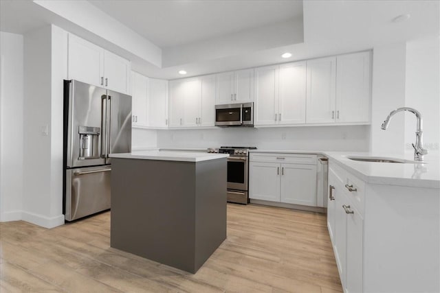 125 Island Way Unit 403, Clearwater, FL 33767 - kitchen featuring appliances with stainless steel finishes, recessed lighting, light wood finished floors, white cabinetry, and a center island