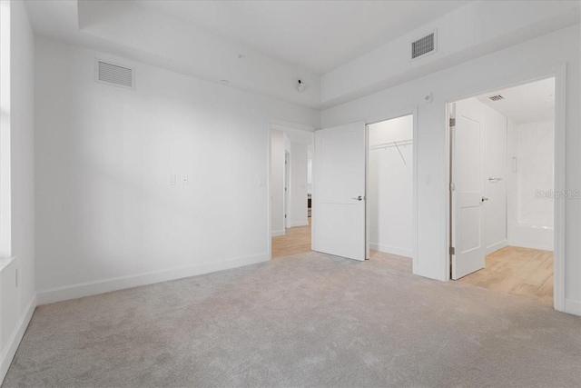 125 Island Way Unit 403, Clearwater, FL 33767 - unfurnished bedroom with light colored carpet and a closet