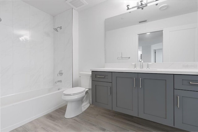 125 Island Way Unit 403, Clearwater, FL 33767 - full bathroom with vanity, wood finished floors, and shower / tub combination