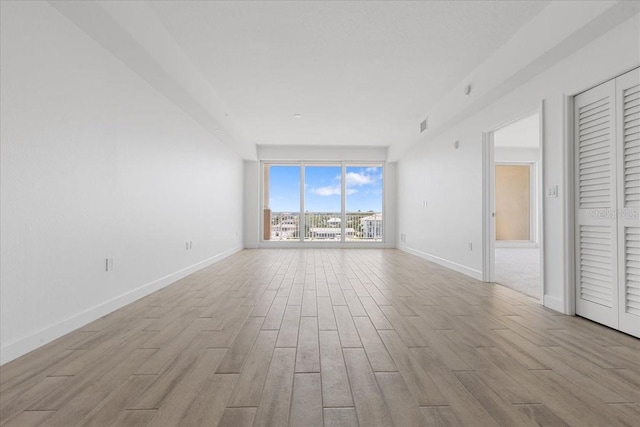 125 Island Way Unit 403, Clearwater, FL 33767 - empty room featuring wood finished floors and floor to ceiling windows