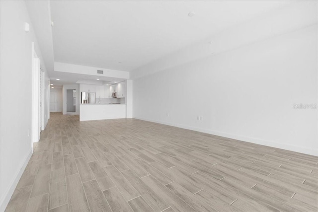 125 Island Way Unit 403, Clearwater, FL 33767 - unfurnished living room featuring light wood-type flooring