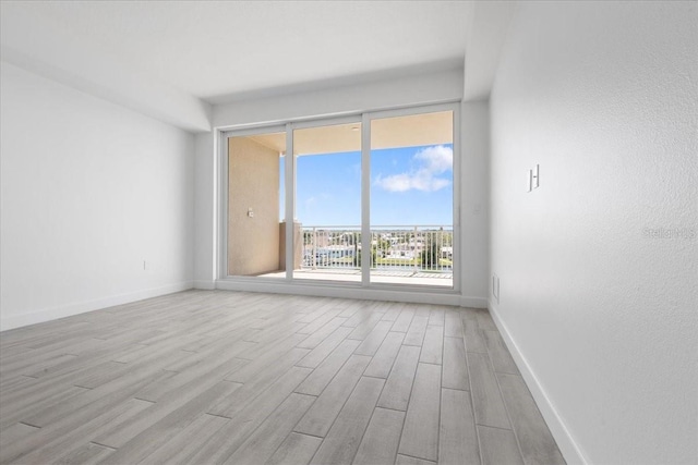 125 Island Way Unit 403, Clearwater, FL 33767 - empty room featuring wood finished floors and baseboards