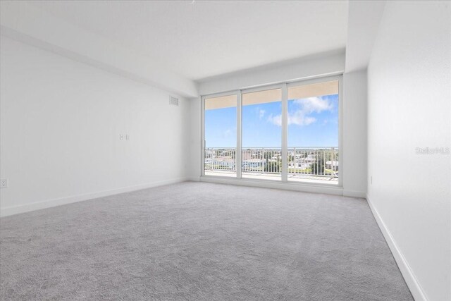 125 Island Way Unit 403, Clearwater, FL 33767 - empty room featuring carpet and baseboards