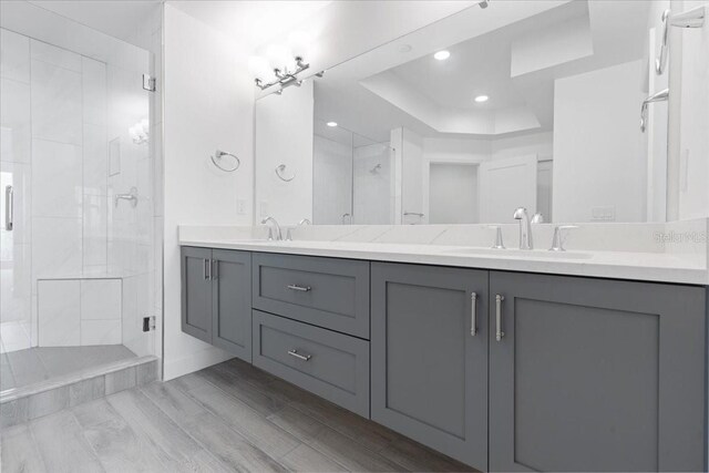 125 Island Way Unit 403, Clearwater, FL 33767 - bathroom with a shower stall, double vanity, recessed lighting, and a raised ceiling