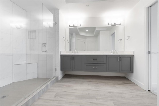 125 Island Way Unit 403, Clearwater, FL 33767 - full bathroom with double vanity, a shower stall, and wood finished floors