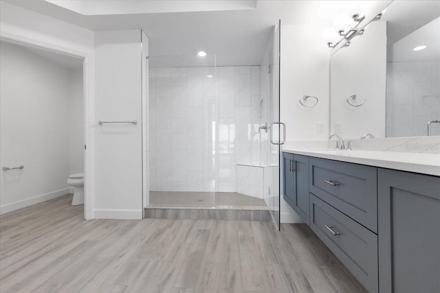 125 Island Way Unit 403, Clearwater, FL 33767 - bathroom with recessed lighting, vanity, a stall shower, and wood finished floors