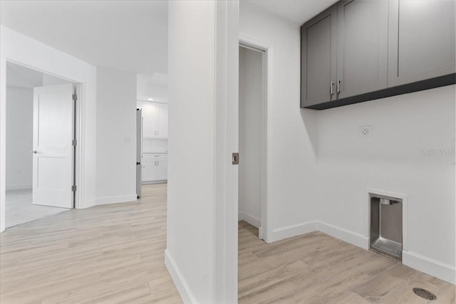 125 Island Way Unit 403, Clearwater, FL 33767 - washroom featuring cabinet space, light wood-type flooring, and hookup for an electric dryer