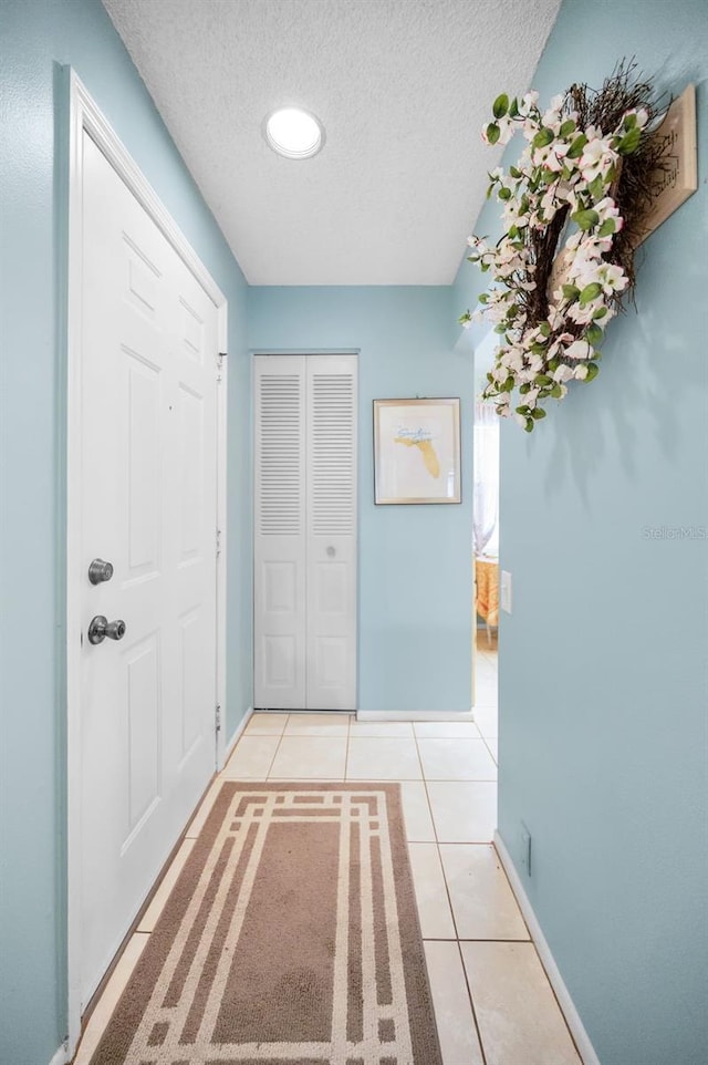 5265 E Bay Dr Unit 313, Clearwater, FL 33764 - hall with a textured ceiling and light tile patterned floors