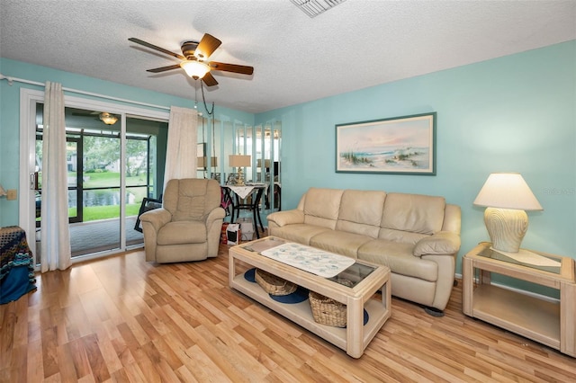 5265 E Bay Dr Unit 313, Clearwater, FL 33764 - living room featuring a ceiling fan, light wood-style floors, and a textured ceiling