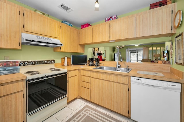 5265 E Bay Dr Unit 313, Clearwater, FL 33764 - kitchen with white appliances, range hood, light tile patterned floors, light countertops, and light brown cabinetry