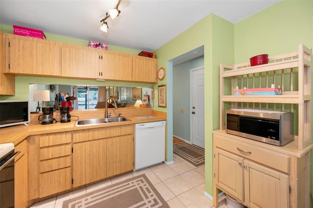 5265 E Bay Dr Unit 313, Clearwater, FL 33764 - kitchen featuring dishwasher, stainless steel microwave, light countertops, light tile patterned flooring, and stove