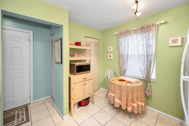 5265 E Bay Dr Unit 313, Clearwater, FL 33764 - dining room featuring baseboards and light tile patterned floors