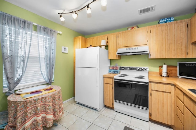5265 E Bay Dr Unit 313, Clearwater, FL 33764 - kitchen with white appliances, range hood, light countertops, and light tile patterned flooring