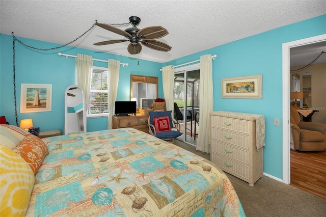 5265 E Bay Dr Unit 313, Clearwater, FL 33764 - carpeted bedroom with access to exterior, multiple windows, a textured ceiling, and a ceiling fan
