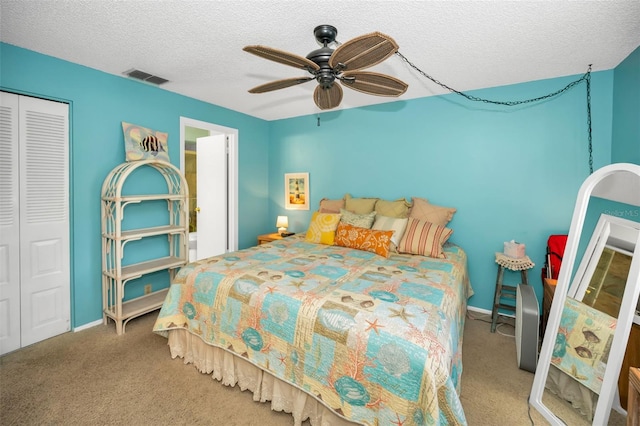 5265 E Bay Dr Unit 313, Clearwater, FL 33764 - bedroom featuring a closet, a textured ceiling, carpet flooring, and a ceiling fan