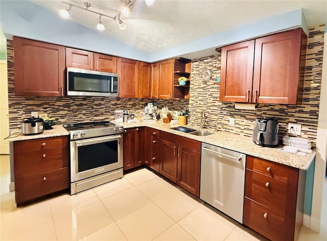 4239 Cardoon Dr, New Port Richey, FL 34653 - kitchen with appliances with stainless steel finishes, decorative backsplash, open shelves, light tile patterned floors, and a textured ceiling