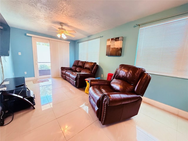 4239 Cardoon Dr, New Port Richey, FL 34653 - living area with tile patterned flooring, a ceiling fan, and a textured ceiling