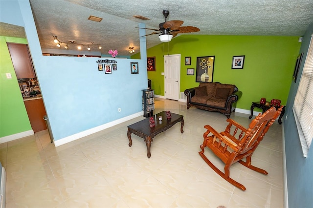4239 Cardoon Dr, New Port Richey, FL 34653 - tiled living room featuring ceiling fan, vaulted ceiling, and a textured ceiling
