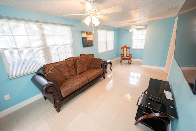 4239 Cardoon Dr, New Port Richey, FL 34653 - living area featuring a textured ceiling, ceiling fan, and light tile patterned floors