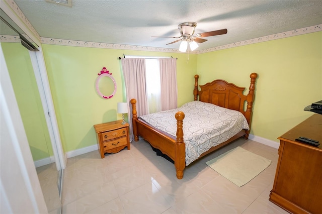 4239 Cardoon Dr, New Port Richey, FL 34653 - bedroom featuring a textured ceiling, ceiling fan, and light tile patterned floors