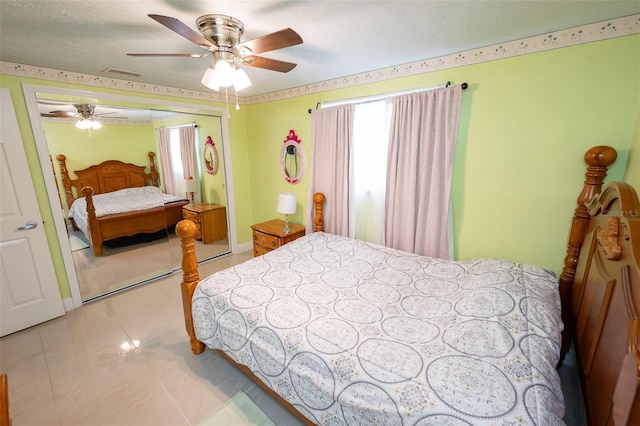 4239 Cardoon Dr, New Port Richey, FL 34653 - bedroom featuring a closet, ceiling fan, and light tile patterned floors