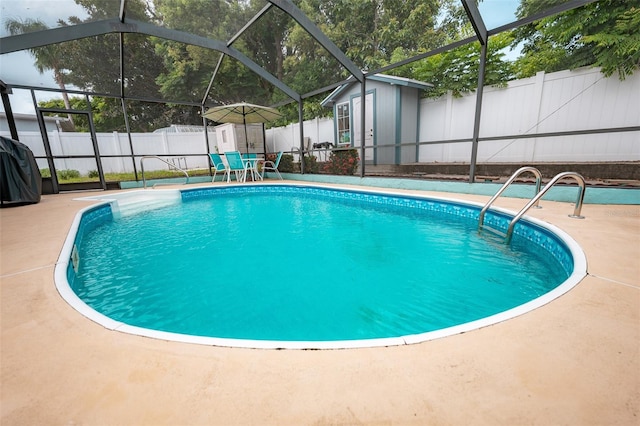 4239 Cardoon Dr, New Port Richey, FL 34653 - view of swimming pool featuring a storage unit, a patio area, a fenced backyard, and glass enclosure