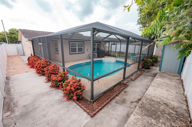 4239 Cardoon Dr, New Port Richey, FL 34653 - view of swimming pool featuring a fenced backyard, a patio, and glass enclosure