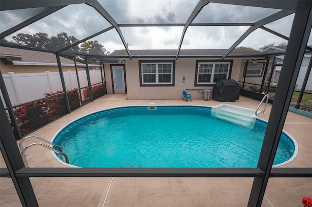 4239 Cardoon Dr, New Port Richey, FL 34653 - view of pool with a patio, grilling area, and glass enclosure