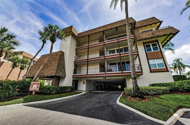 3021 Countryside Blvd Unit 28A, Clearwater, FL 33761 - view of building exterior featuring an attached garage and asphalt driveway