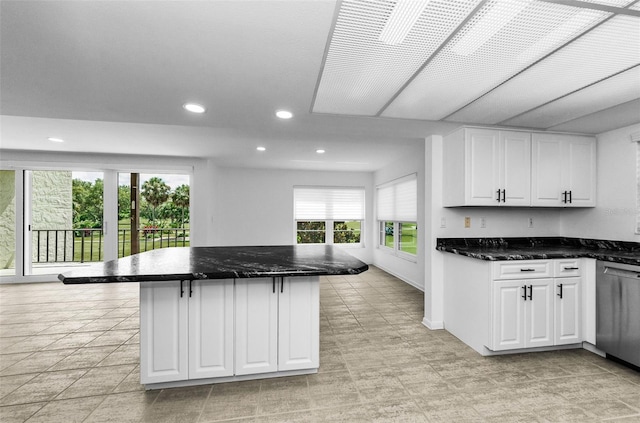 3021 Countryside Blvd Unit 28A, Clearwater, FL 33761 - kitchen featuring stainless steel dishwasher, plenty of natural light, recessed lighting, white cabinets, and a center island
