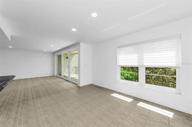 3021 Countryside Blvd Unit 28A, Clearwater, FL 33761 - unfurnished living room featuring healthy amount of natural light and recessed lighting