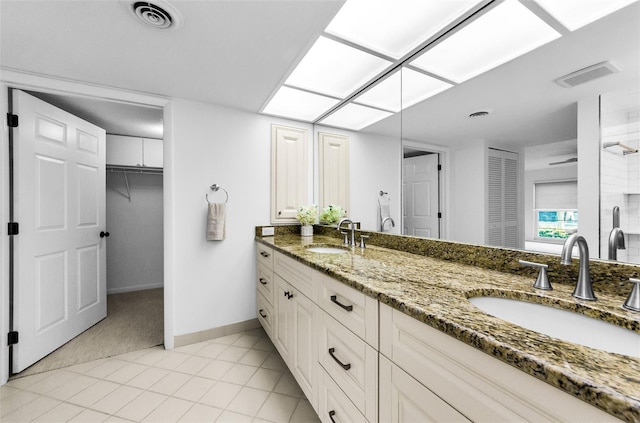 3021 Countryside Blvd Unit 28A, Clearwater, FL 33761 - bathroom featuring double vanity, tiled shower, and tile patterned flooring